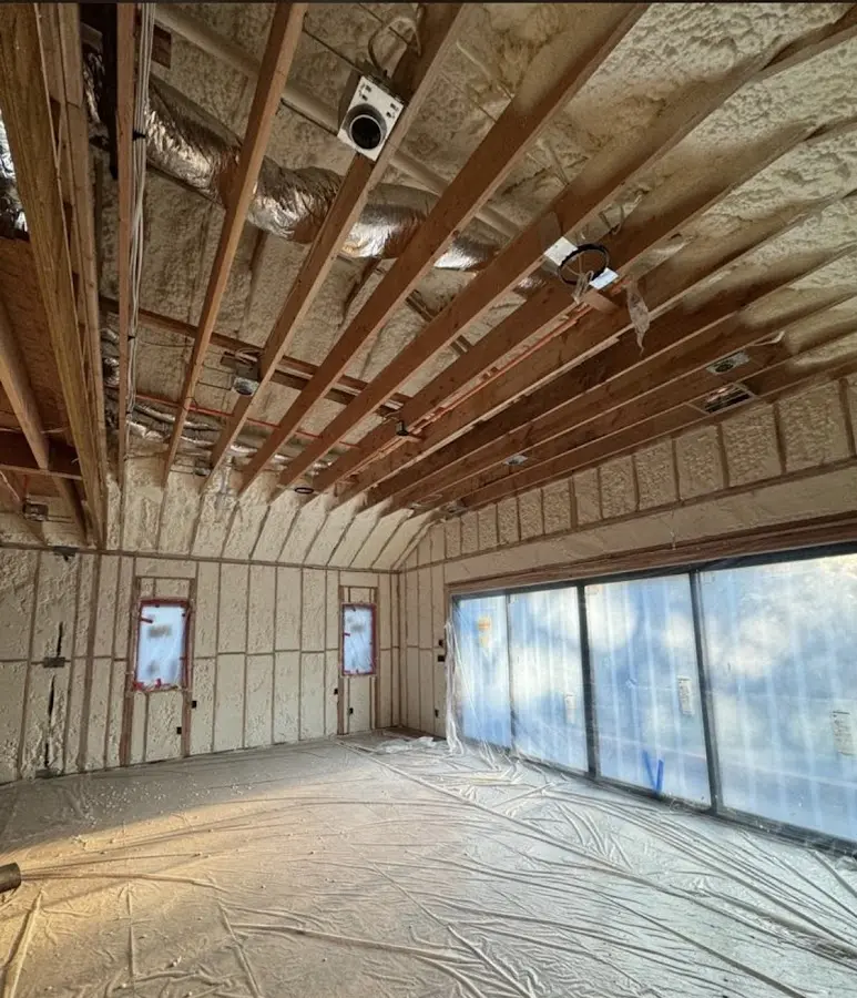 Interior walls and ceiling insulated with spray foam during new construction in Bensville